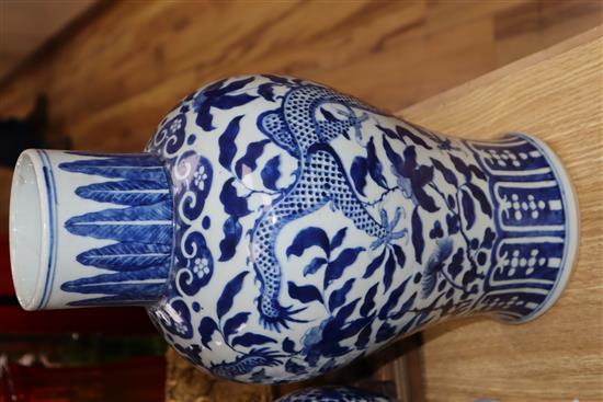 A large blue and white Chinese and a smaller similar vase with wooden cover, two stands and a cover